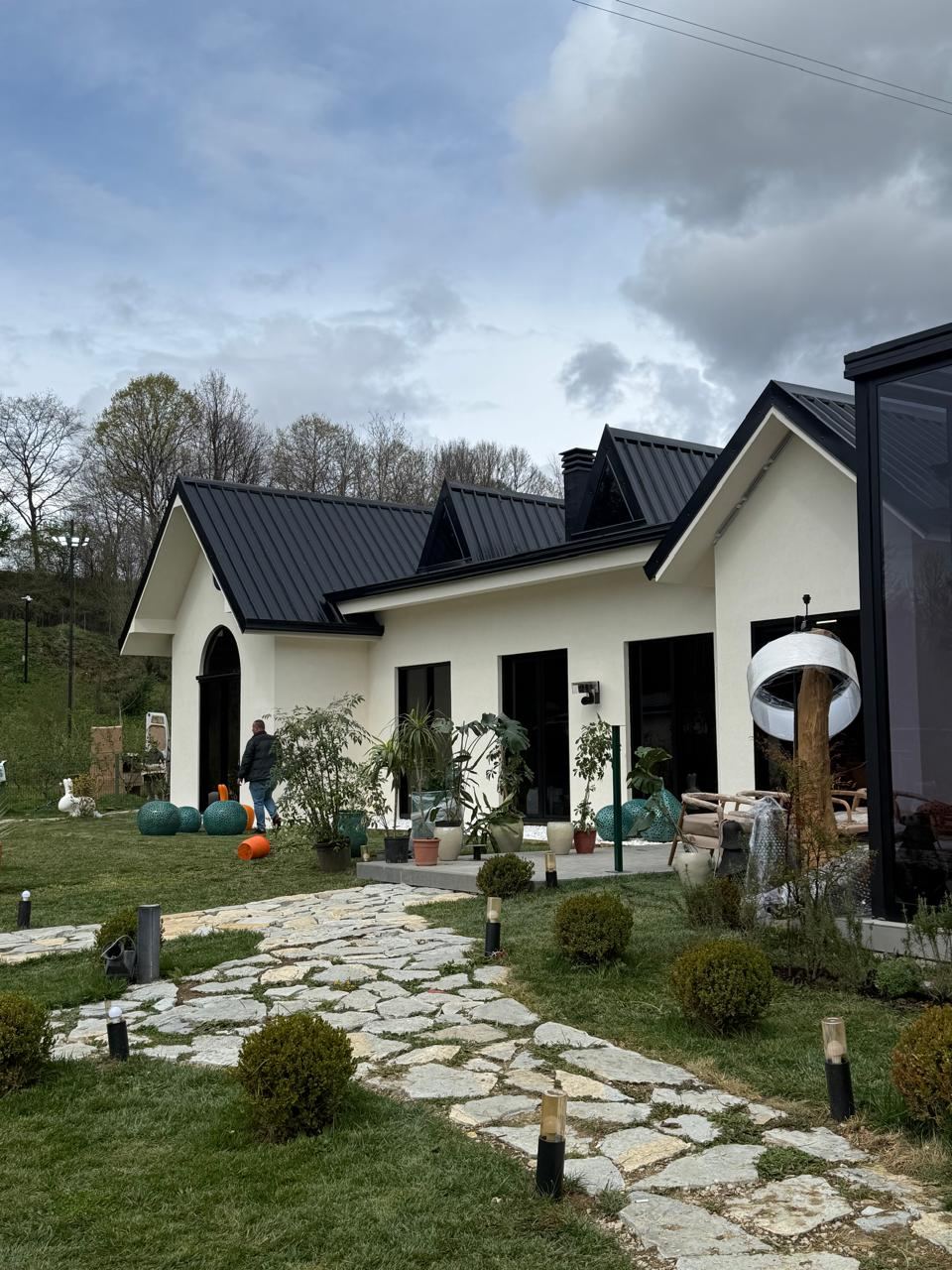 Ferma VIP nearing completion, exterior finishes and landscaping in progress around the house