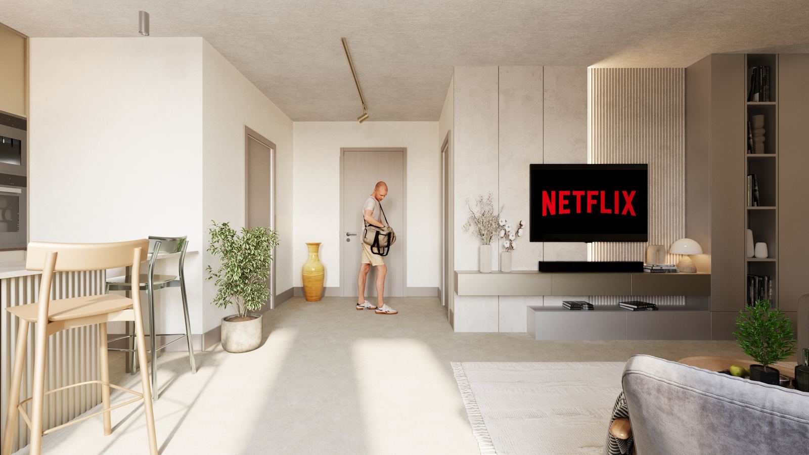 Open-plan living area with integrated kitchen, soft beige palette, custom TV wall, and natural daylight defining the space.