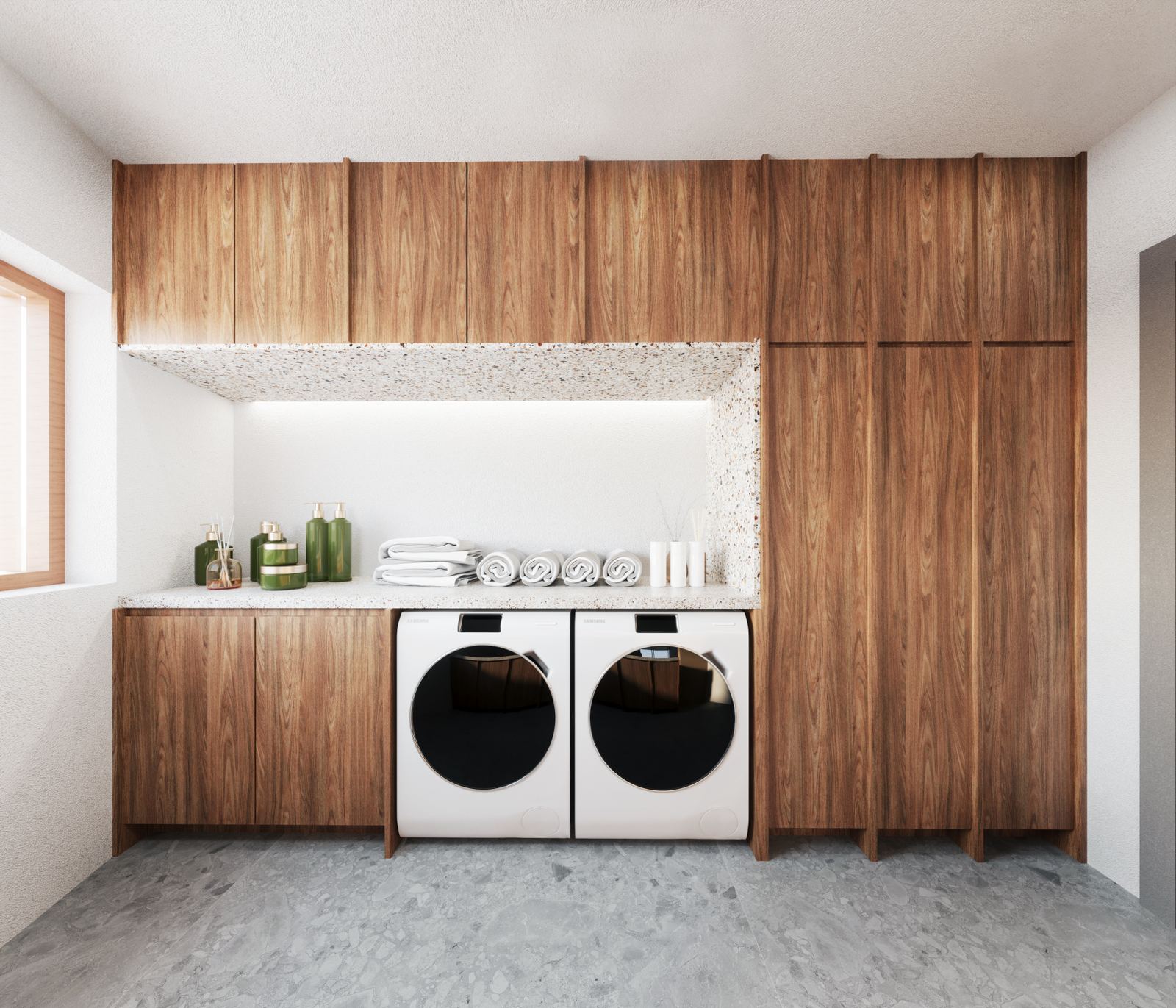 Laundry room with built-in storage, integrated appliances, and a clean composition of wood and textured surfaces.